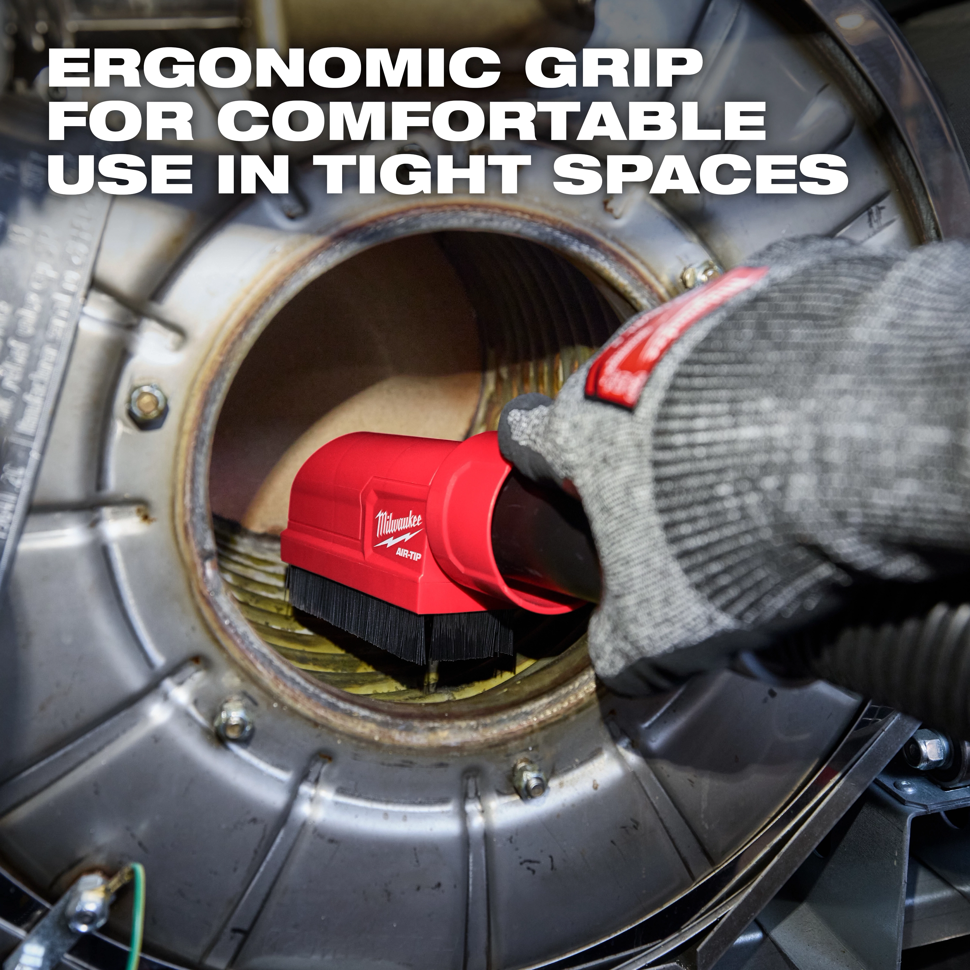 The AIR-TIP Boiler Coil Cleaning Brush Tool with an ergonomic grip is held by a gloved hand inside a boiler.