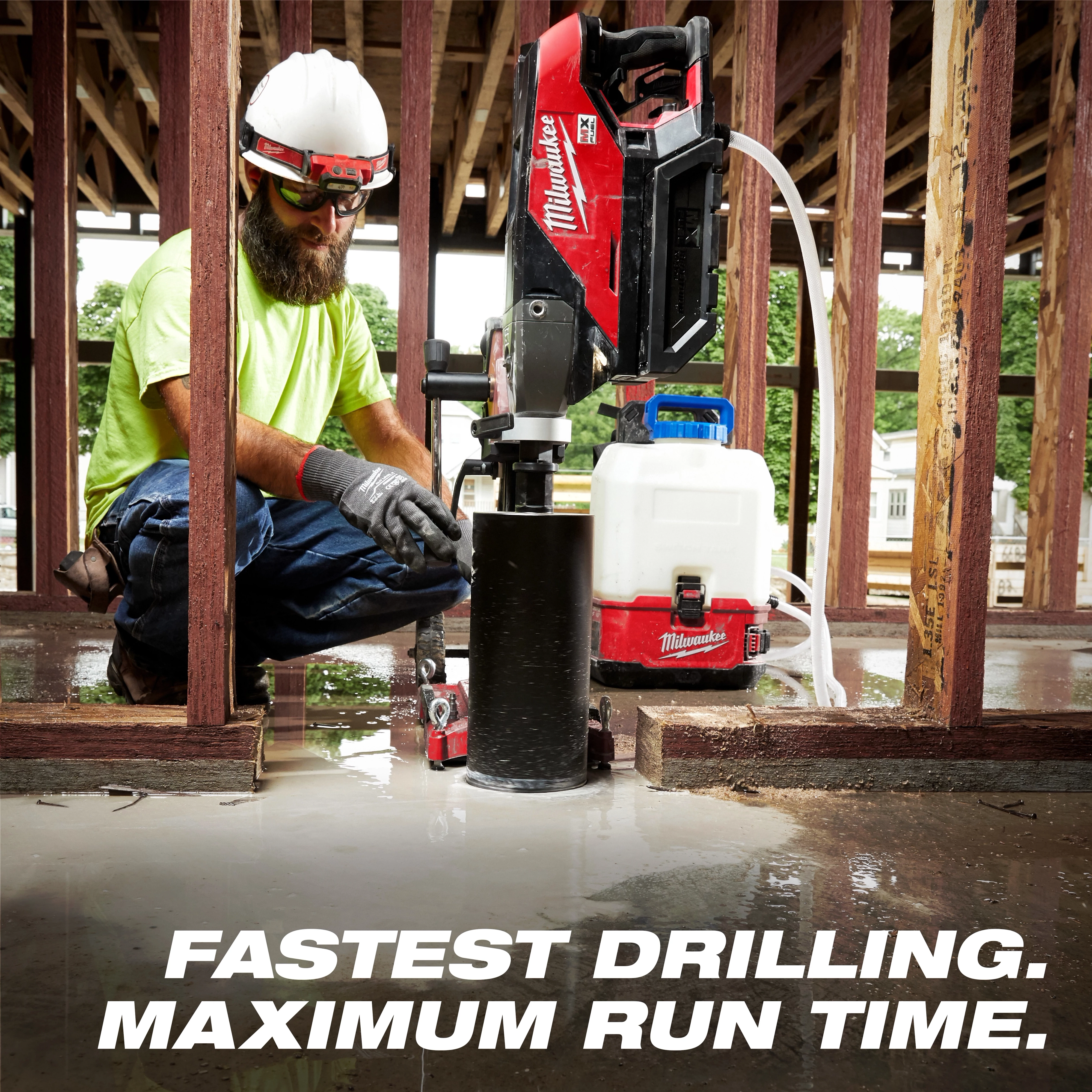 A construction worker uses the Diamond Ultra Wet Core Bits USP Graphic for drilling concrete, with a white and red water tank connected.