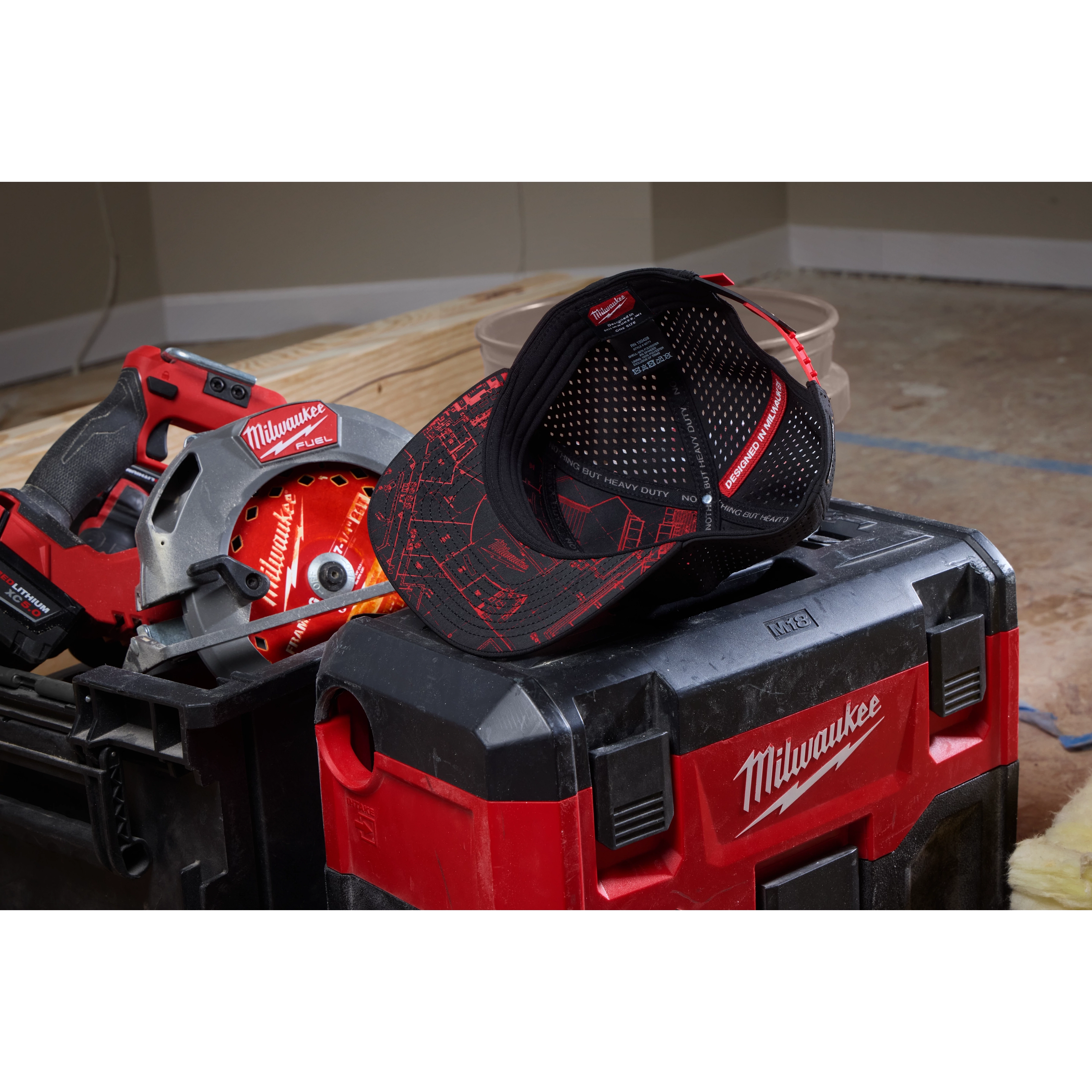 Flat Brim Snapback hat resting on a red and black toolbox with a power saw and a power drill partially visible in the background.