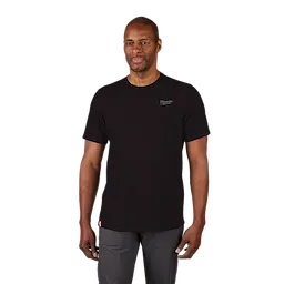 Man wearing a black Hybrid Work Tee with short sleeves, small logo on upper left chest, and red tag near hem, paired with gray pants.
