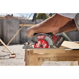 6-1/2” 24T Thick Kerf Framing Circular Saw Blade cutting a wooden board on a sawhorse outdoors