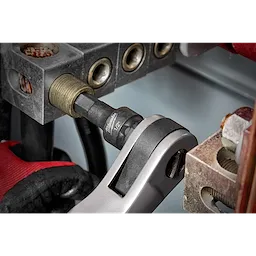 1/2" Drive 1/2" Hex Bit Socket attached to a socket wrench in use, tightening a hex bolt in an industrial machinery setting.