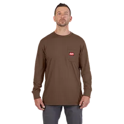 A man wearing a Heavy Duty Pocket T-Shirt – Brown, featuring a chest pocket with a red logo patch.