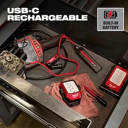 Milwaukee USB-C rechargeable work lights and charger arranged in a tool drawer.
