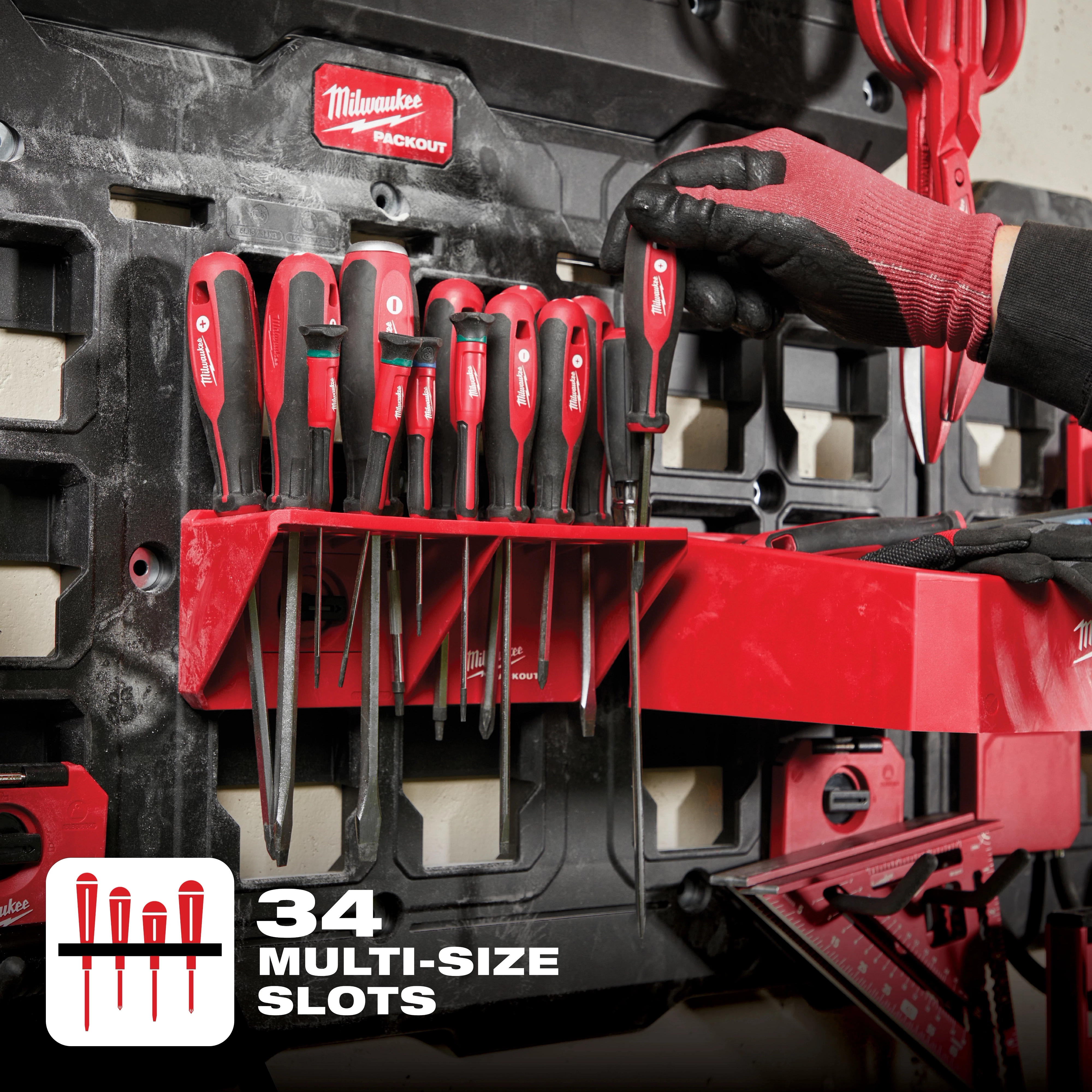 Milwaukee Packout Screwdriver Rack with 34 multi-size slots, holding various red-handled screwdrivers on a black wall mount.