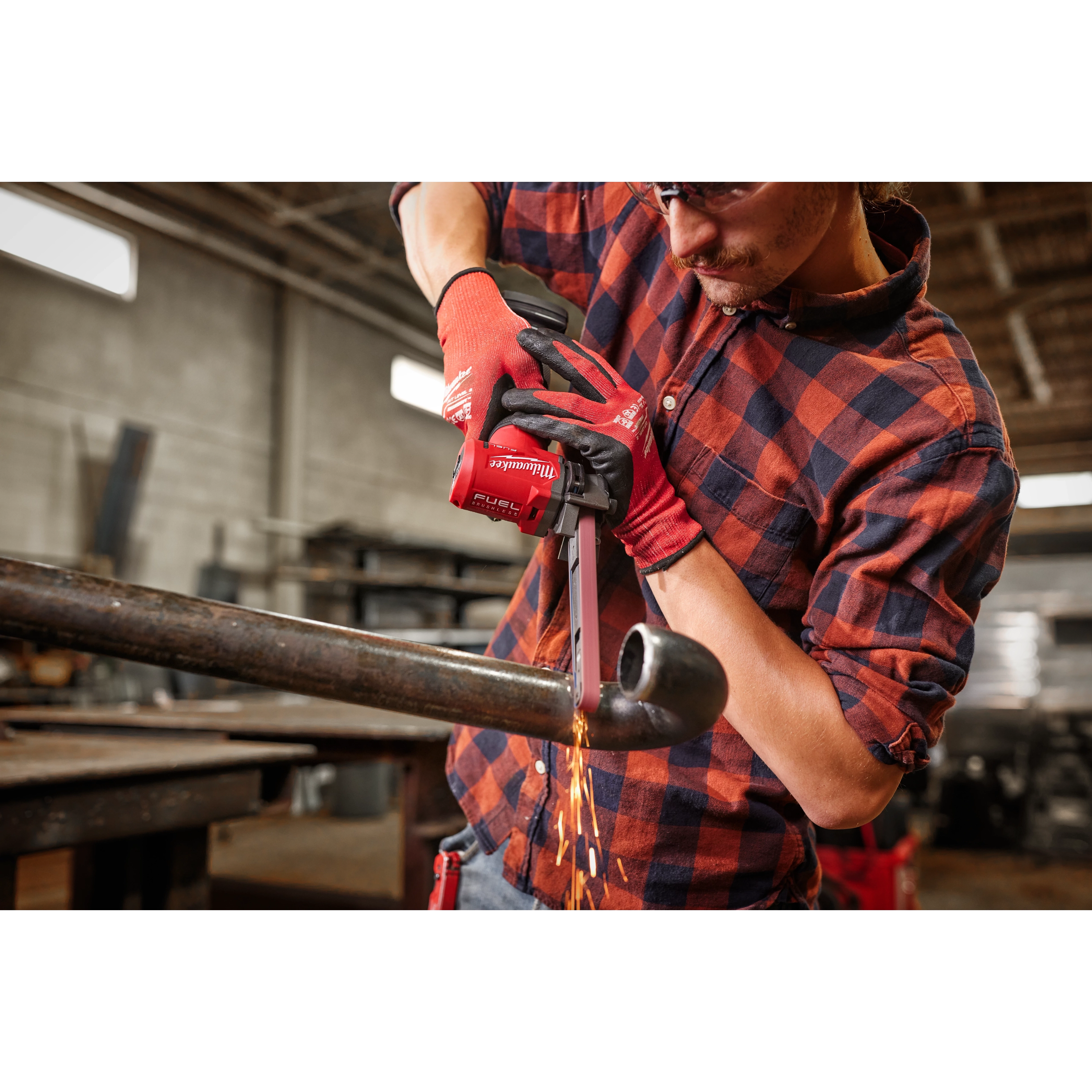 Image of the Milwaukee M12 FUEL 1/2" X 18" Bandfile being used by a worker on a pipe