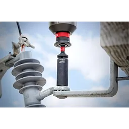 9/16"-3/4" 12PT 2-in-1 Socket attached to a power tool being used on an electrical insulator, against a sky background.