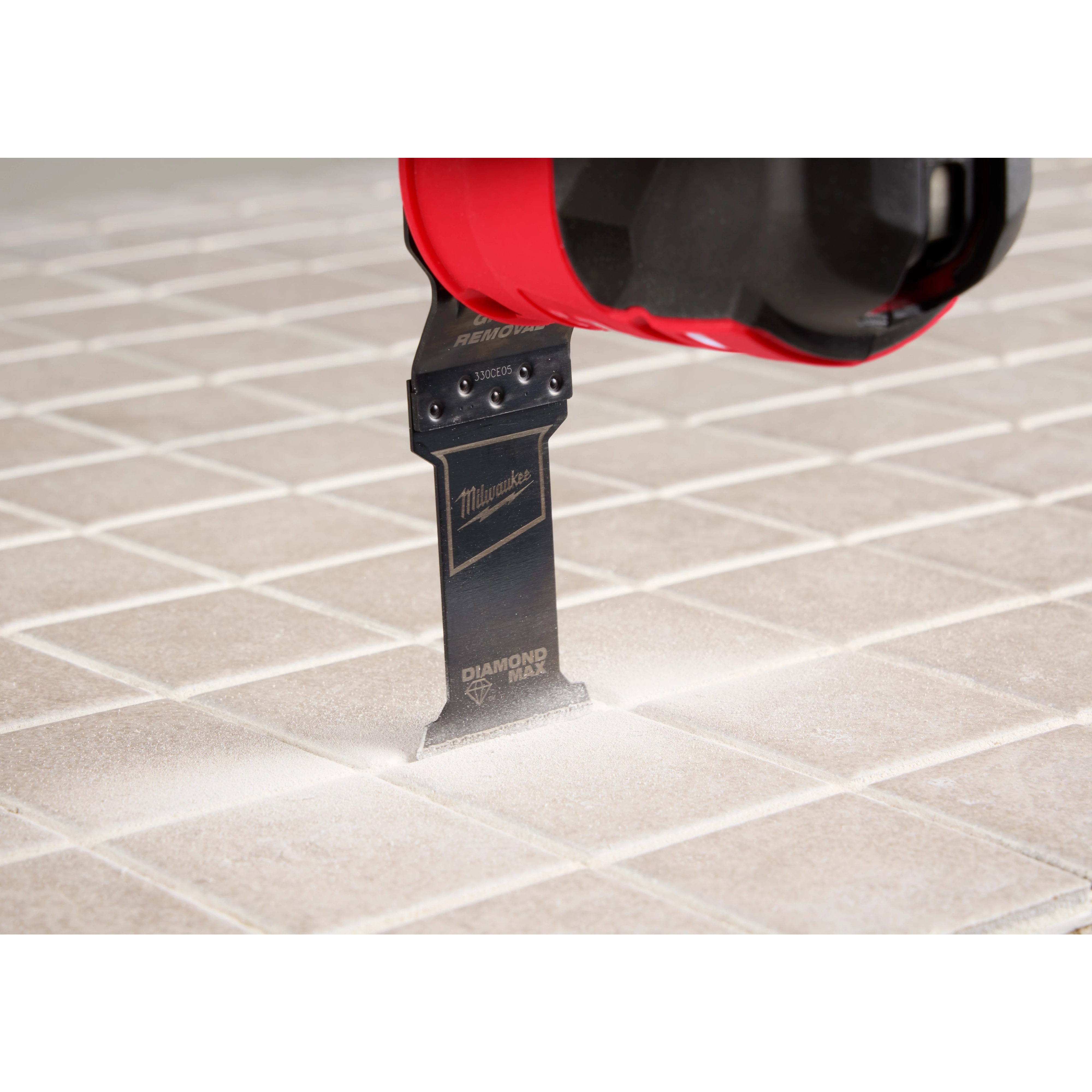Image of the OPEN-LOK™ DIAMOND MAX™ Diamond Grit Grout Removal Multi-Tool Plunge Blade being used in a Milwaukee Multi-Tool on tile