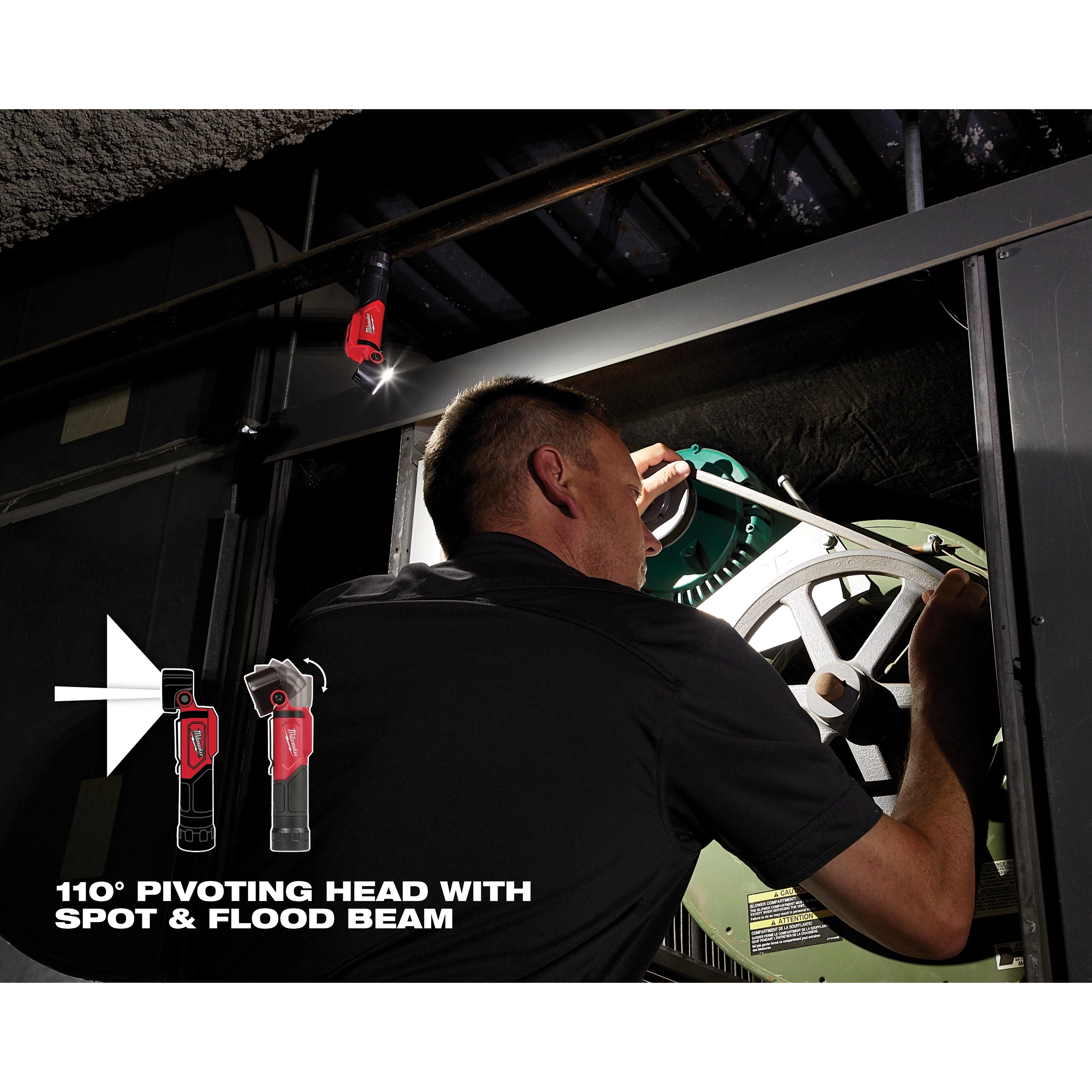 Man using REDLITHIUM USB Pivoting Flashlight to repair machinery in a dark industrial setting, demonstrating its pivoting head and flood beam.