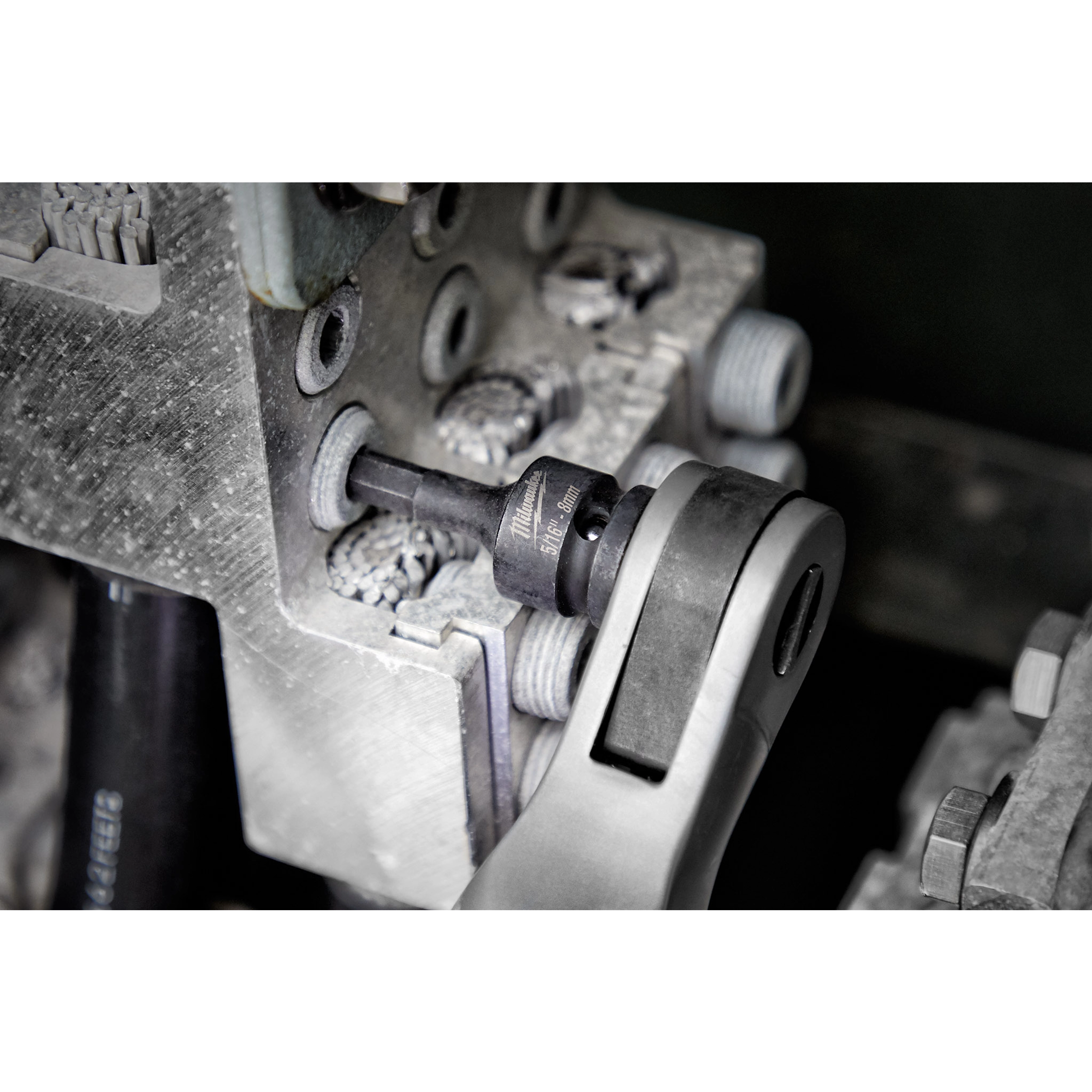 Shockwave Lineman's 6PT 9/16" x 3/4" 2-in-1 Socket attached to a ratchet wrench being used on industrial equipment.