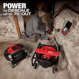A person uses a Milwaukee descaling tool to descale pipes in a dimly lit basement. The product's slogan emphasizes its power to descale up to 75 feet out. The setup includes Milwaukee equipment such as a hose reel and display screen on the floor.