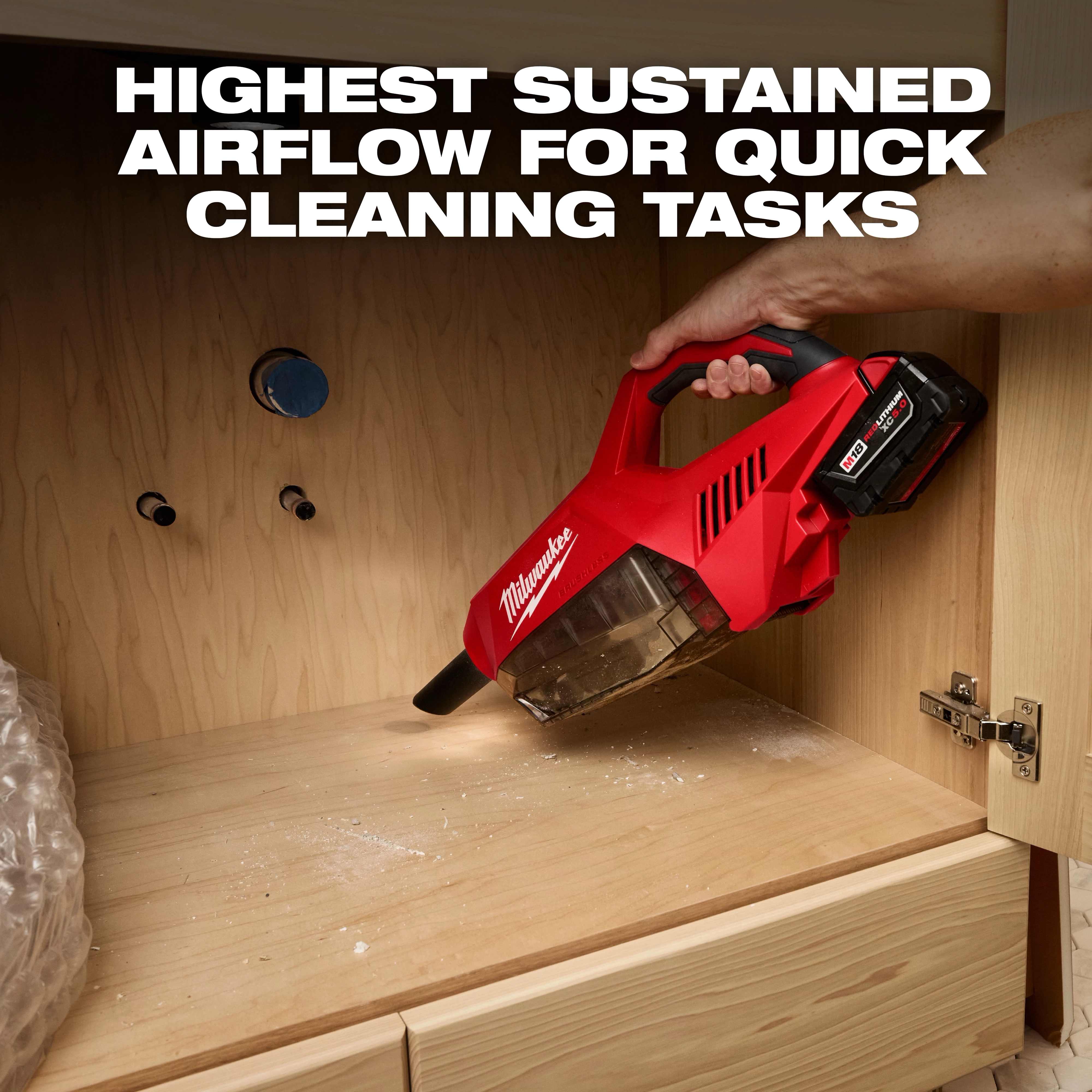 Person using the M18 Brushless Handheld Vacuum to clean wood dust inside a cabinet, with text "Highest Sustained Airflow for Quick Cleaning Tasks."