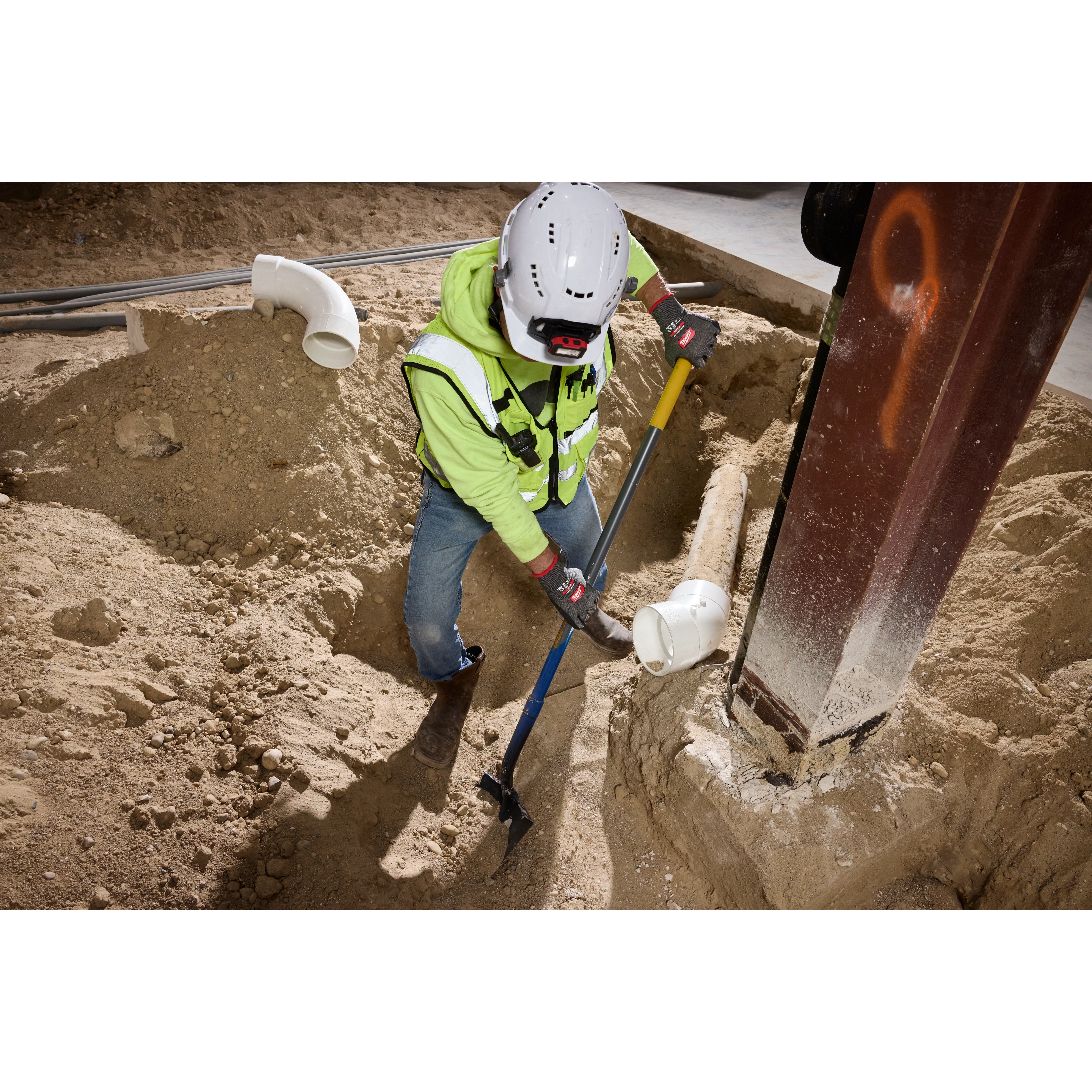 Worker digging in a trench wearing Cut Level 5 High Dexterity Nitrile Dipped Gloves with WEAR-DEFENSE Protection.