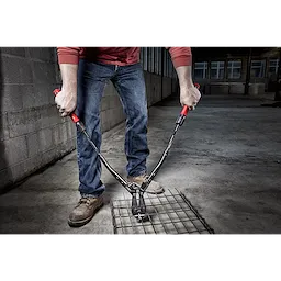 Person using 24" Adaptable Bolt Cutter with POWERMOVE Extendable Arms to cut through metal wire in an industrial setting.