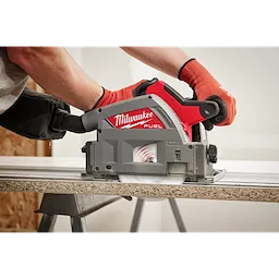 Person using a 6-1/2" 52T Laminate Track Saw BLD to cut a piece of wood, showing the tool's close-up while in action.