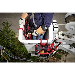 A worker in a utility bucket uses the 2 Inch Bucket Hook to hang various tools and equipment over the edge for easy access.