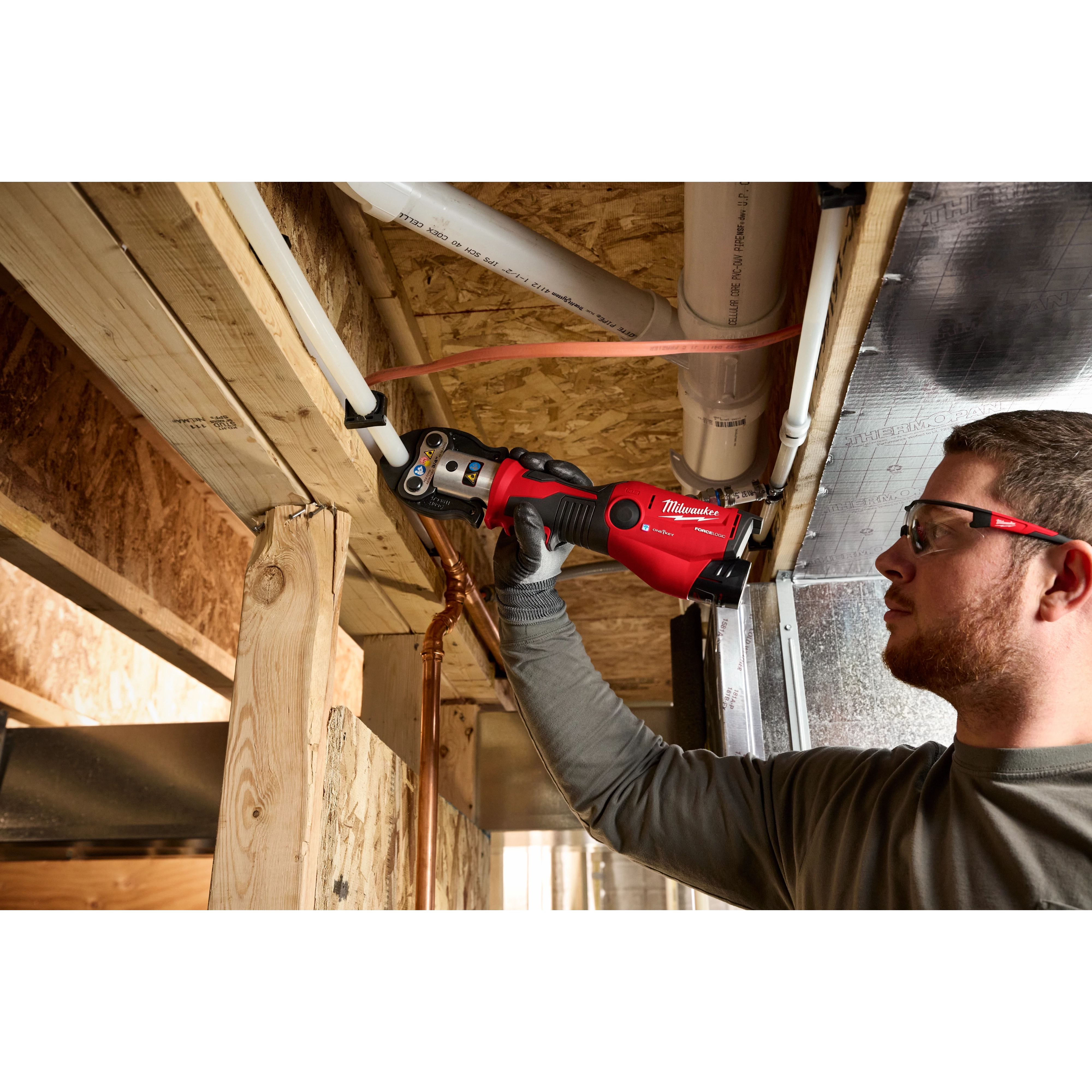 M12 FORCE LOGIC Press Tool Kit w/ ONE-KEY being used to work on pipes in a construction setting.