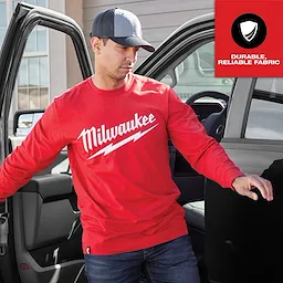 Red Heavy Duty Tee - Long Sleeve Logo Feature Shot with "Milwaukee" logo in white script, worn by a man exiting a vehicle.