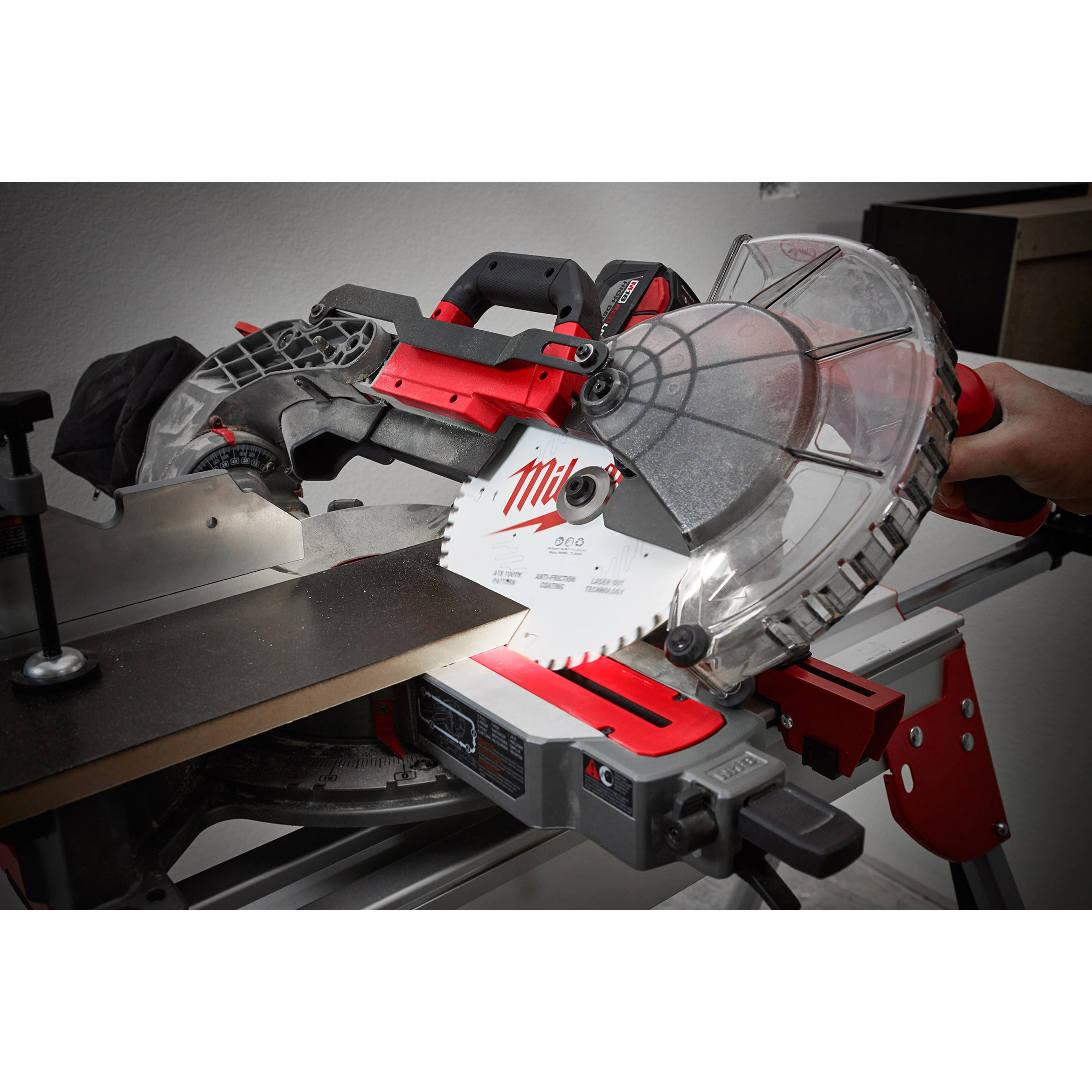 10" 60T Fine Finish Circular Saw Blade installed on a miter saw, cutting a piece of wood. The blade is white with red detailing.