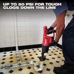 A person uses the Milwaukee Airsnake Drain Cleaning Machine on a clogged bathroom sink pipe. The machine claims to provide up to 50 PSI pressure to clear tough clogs down the line. The image illustrates its effectiveness in clearing buildup within pipes.