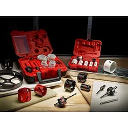 Carbide%20Grit%20Hole%20Saw product consisting of red and white hole saws displayed in red carrying cases. Various sizes of saws and two drill bits are spread on a wooden surface alongside the cases, suggesting a comprehensive set suitable for drilling. Includes both open and closed case arrangements.