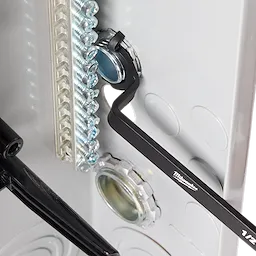 The 3 PC Locknut Wrench Set by Milwaukee is shown in use, tightening a locknut inside an electrical panel. The wrenches have a black finish and are designed for efficient fastening in tight spaces.