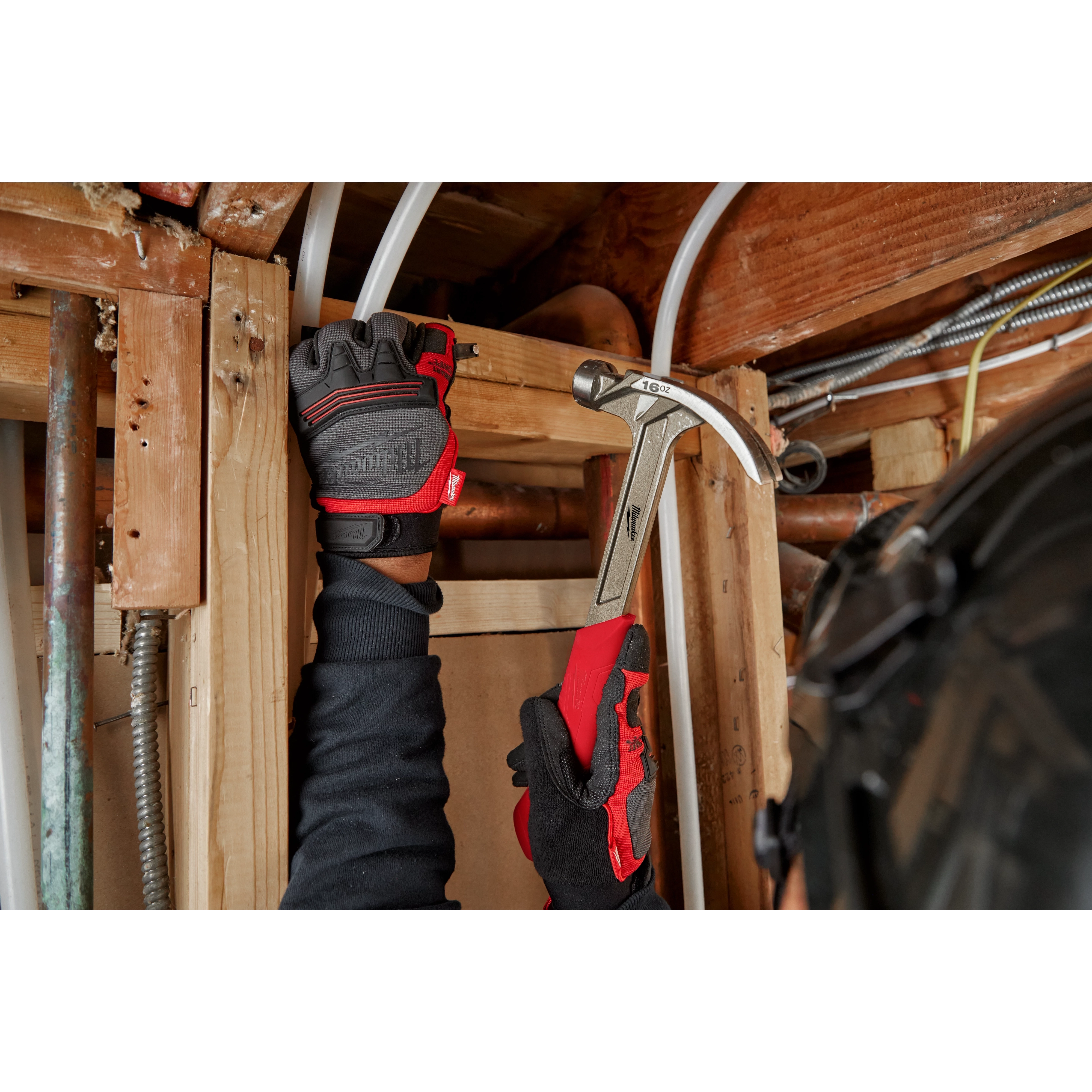 Worker using the Hammer Expansion on the jobsite to hammer in a nail