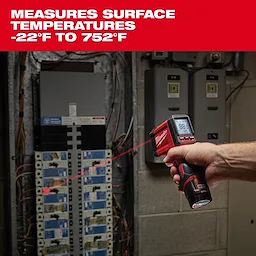 A hand holds a Milwaukee Laser Thermometer aimed at an electrical panel, displaying a temperature reading. The device measures surface temperatures ranging from -22°F to 752°F.