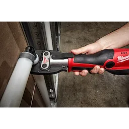 A 1/2" PEX Crimp Jaw for M18 FORCE LOGIC Press Tool is being used to crimp tubing in a workshop setting.