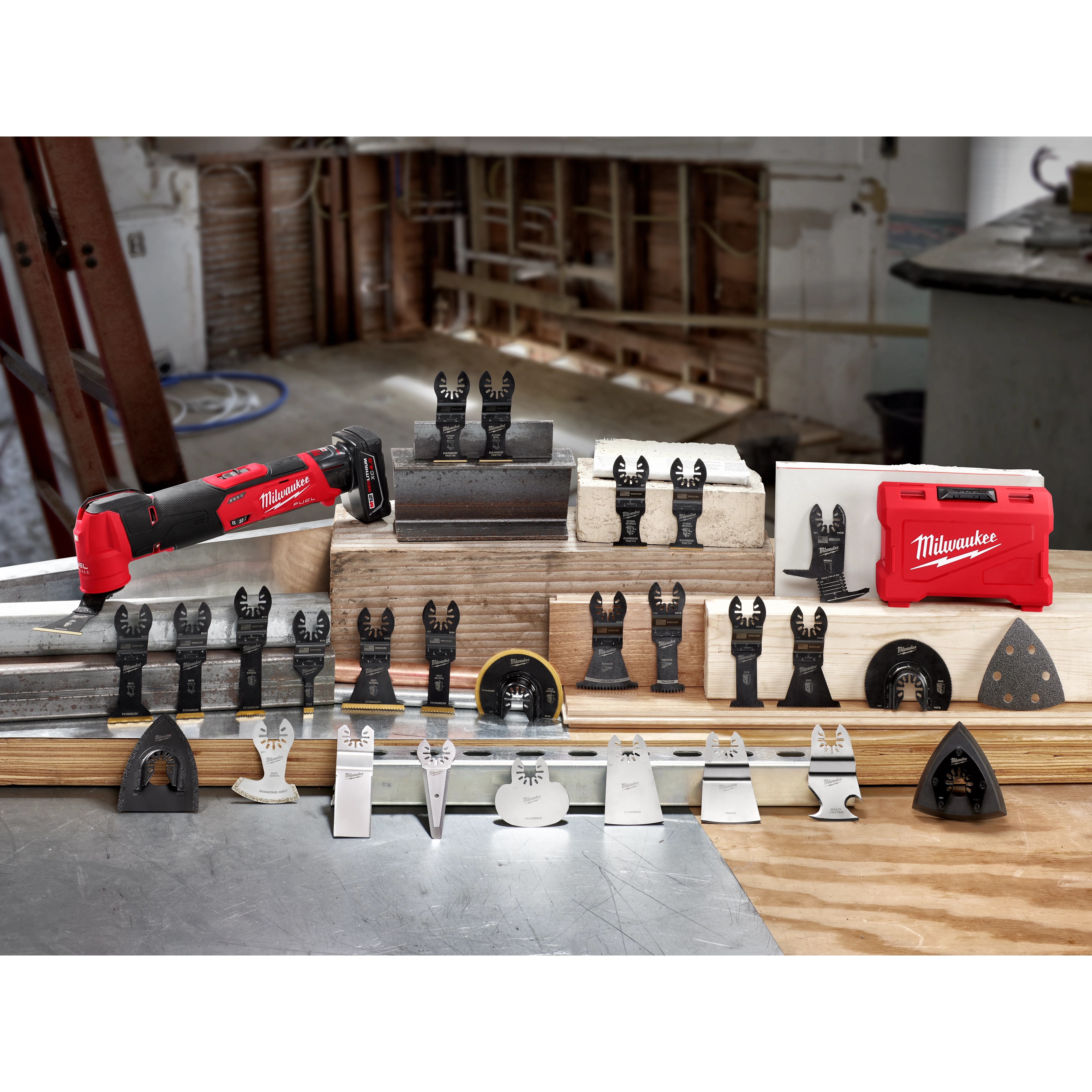 March 2021 OMT Family shot features a red Milwaukee oscillating multi-tool with various attachments and accessories displayed on wooden blocks.
