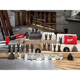 March 2021 OMT Family shot features a red Milwaukee oscillating multi-tool with various attachments and accessories displayed on wooden blocks.