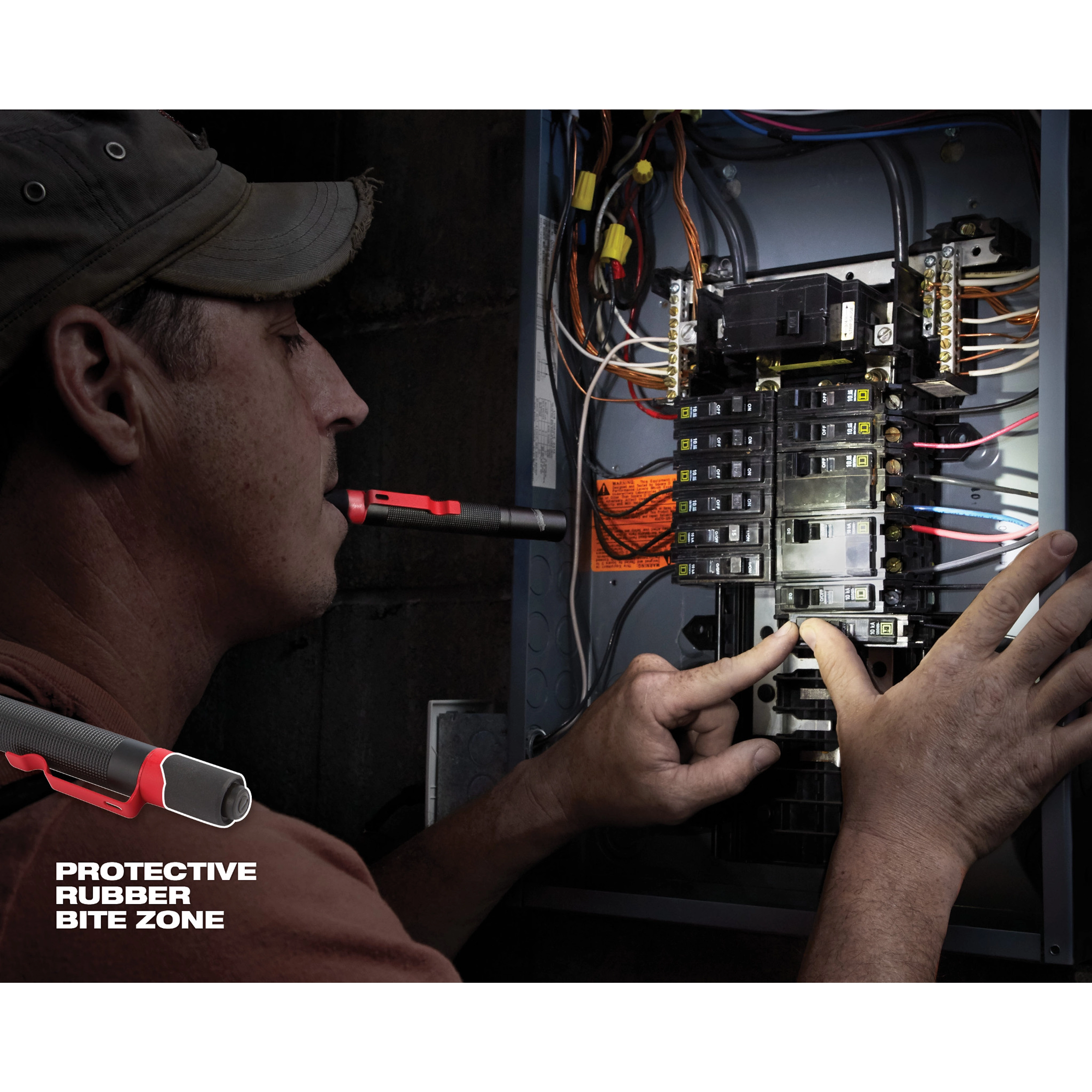 A person uses a Penlight with a protective rubber bite zone while working on an electrical panel.