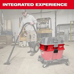 The image features the Milwaukee NEXUS™ Dedicated Debris Separator, a red and black heavy-duty vacuum attachment designed for construction or industrial environments. A worker uses the separator to collect debris on the floor. The text "INTEGRATED EXPERIENCE" is prominently displayed in red above the product.