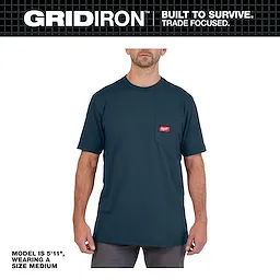 Model wearing the GRIDIRON Pocket T-Shirt - Short Sleeve, size medium in navy. T-shirt features a chest pocket with a red logo tag.