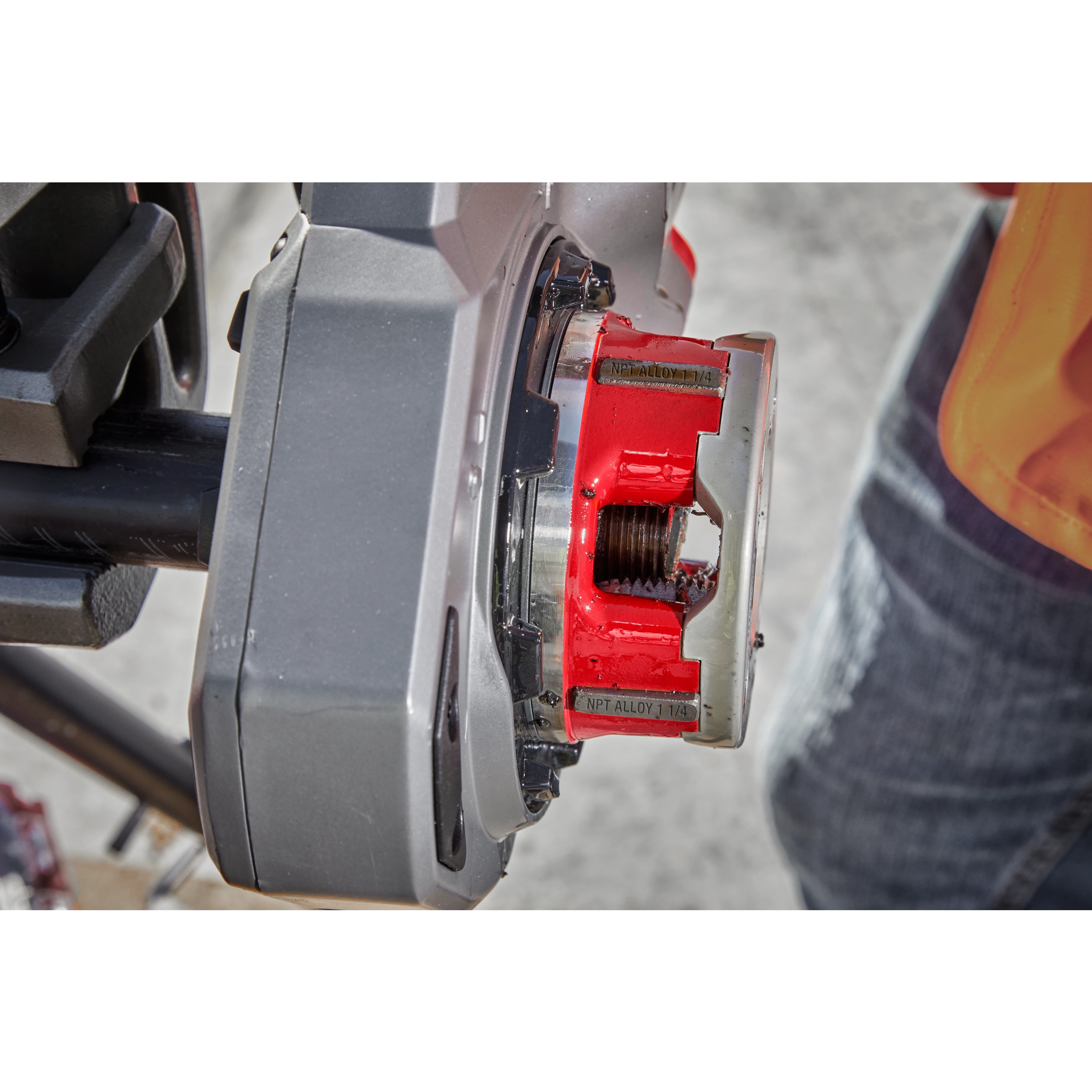 Worker using the 1-1/4" ALLOY NPT Compact Forged Aluminum Die Head