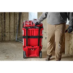 Image of the Milwaukee PACKOUT Rolling Tool Box with Low-Profile Handle being used by a worker on a jobsite