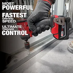 A person uses a power drill from the M18 FUEL 7-Tool Combo Kit to drill into metal.  The drill features the M18 REDLITHIUM battery.