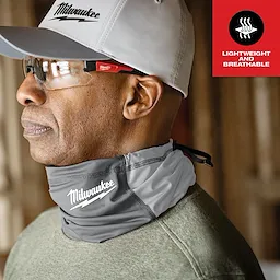 Person wearing a gray WORKSKIN Performance Neck Gaiter with white stitching and a logo, advertised as lightweight and breathable.