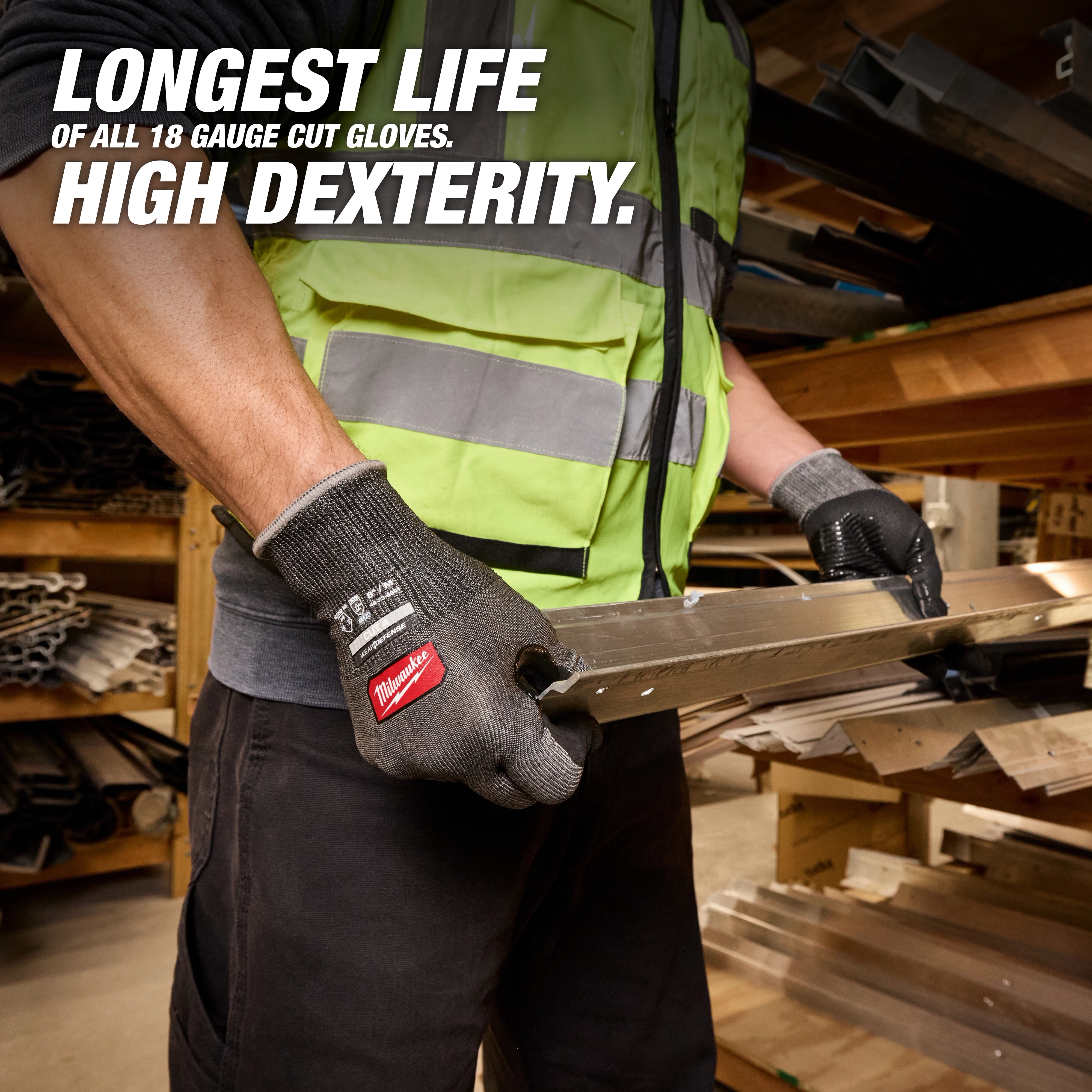 Worker wearing Cut Level 4 High Dexterity Nitrile Dipped Gloves w/ WEAR-DEFENSE Protection holding metal beam.
