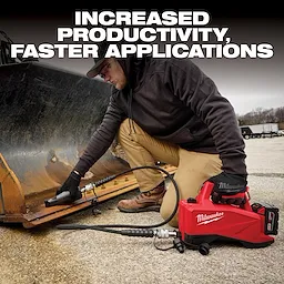 A person kneels on the ground and uses a Milwaukee hydraulic tool to repair heavy machinery. The tool is red, portable, and connected to a hose, emphasizing increased productivity and faster applications. Industrial equipment and trucks are visible in the background.