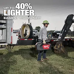 A worker in a hard hat carries the MX FUEL™ Electrofusion Processor on a job site. The text reads, "Up to 40% lighter, easiest transport," highlighting the product's portability. The worker stands near construction equipment and a truck with tools.
