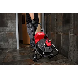 Man easily moving the M18 Drum Machine after drain maintenance