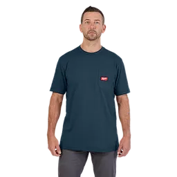 Heavy Duty Pocket T-Shirt in Blue, worn by a standing model with short brown hair. The shirt has a chest pocket with a red tag.