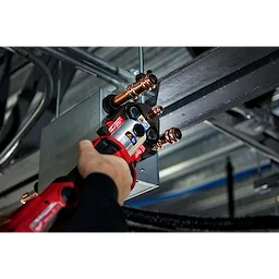 Person using the M18 FORCE LOGIC Press Tool Kit with One-Key and 1/4"-7/8" Streamline ACR Jaws to press copper pipes.