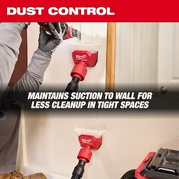 AIR-TIP Compact Dust Collector being used to maintain suction against a wall for easier cleanup in tight spaces.