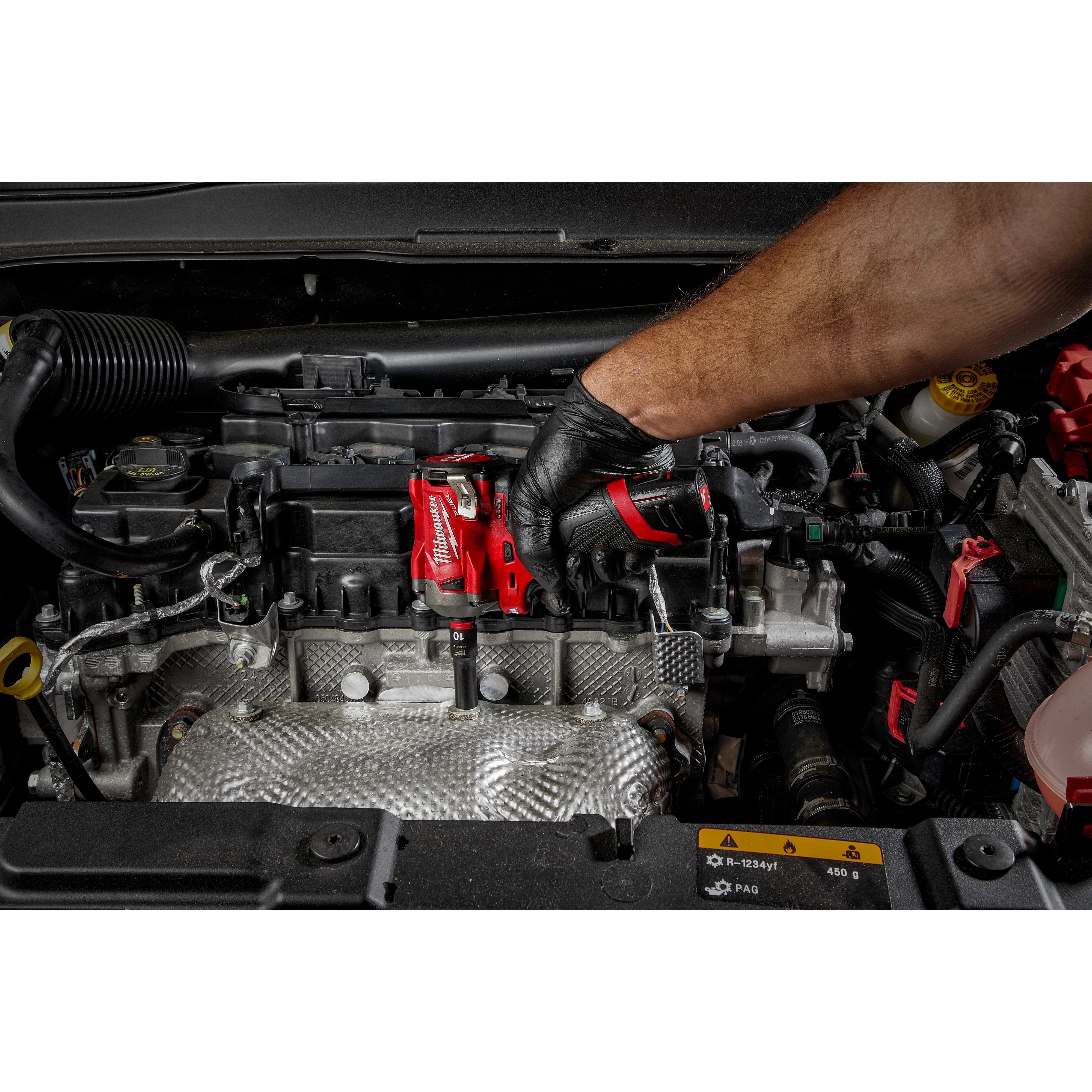Mechanic using a red impact wrench with a SHOCKWAVE%20Impact%20Duty%201/4%22%20Drive%2014MM%20Deep%206%20Point%20Socket on a car engine.