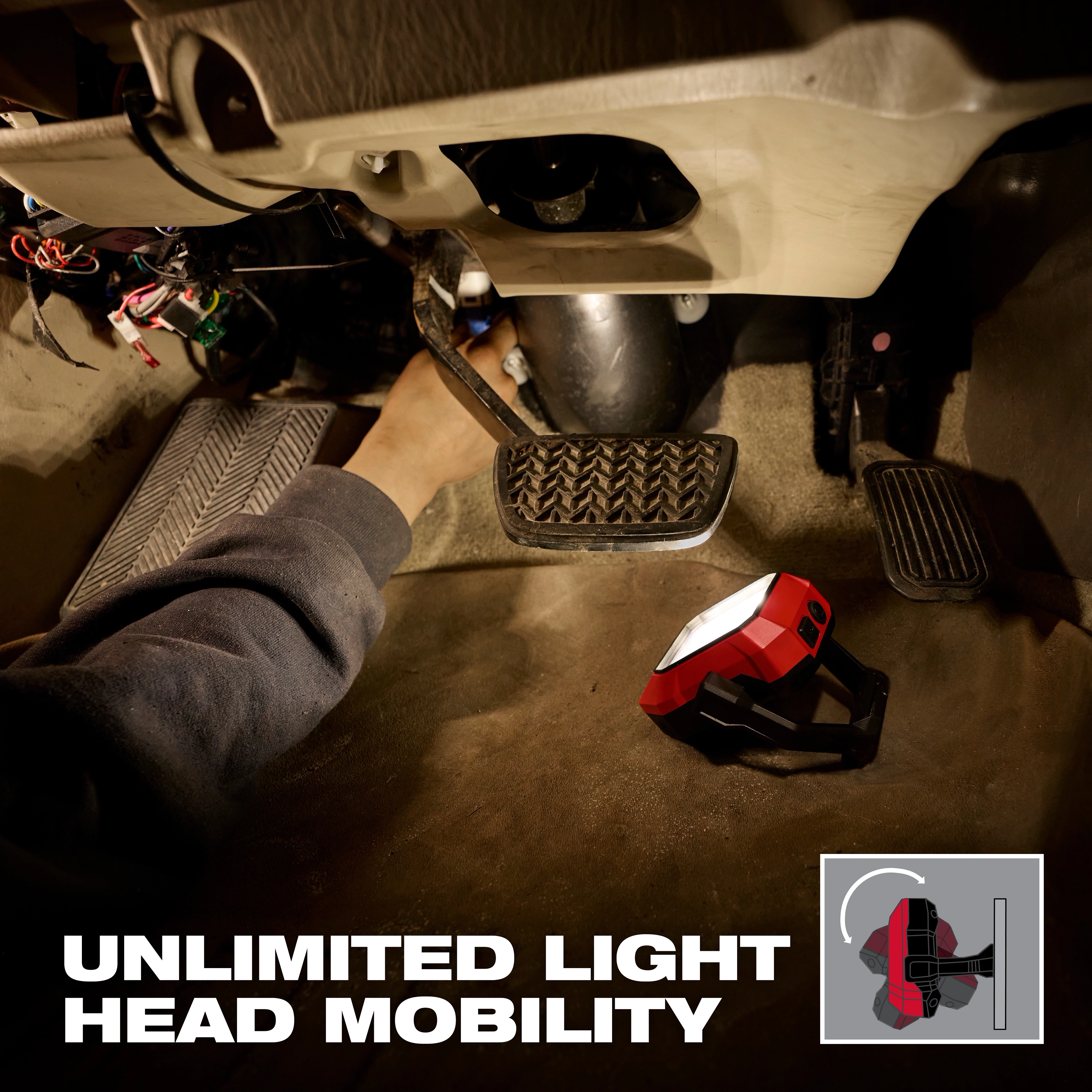 Milwaukee Rechargeable Pivoting Task Light w/ Spot Mode illuminating work under a vehicle dashboard.