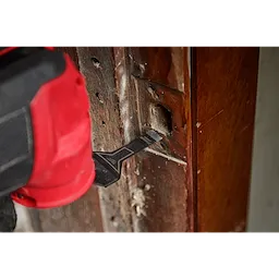 Milwaukee Open-Lok 3/8" Bi-Metal Multi-Material Multi-Tool Blade attached to a red multi-tool, cutting into a wooden surface.