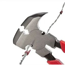 Comfort Grip Fencing Pliers with red handles are cutting a piece of twisted metal wire. The pliers feature sharp cutting edges and multiple gripping slots for various wire sizes.