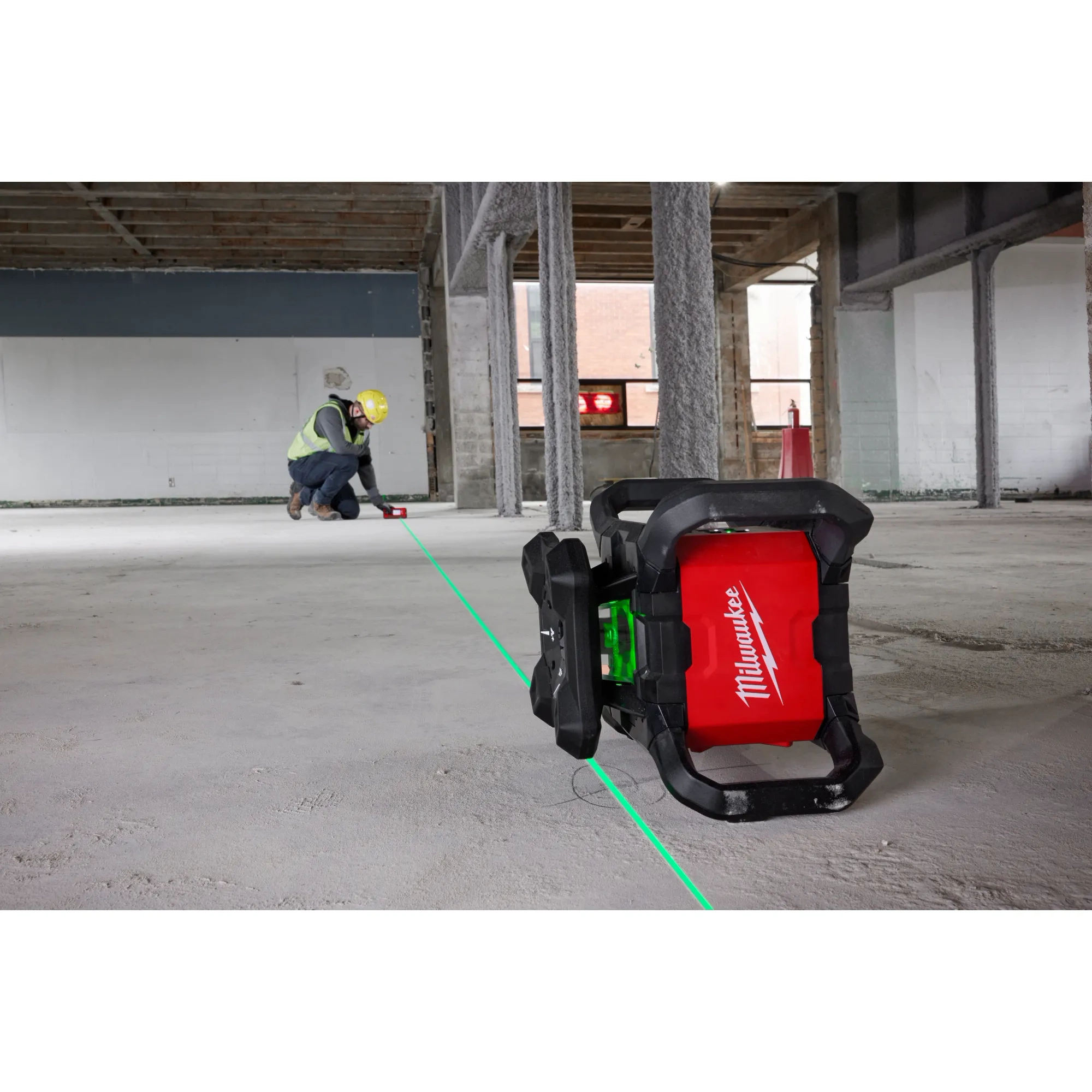 Image of the Milwaukee M18 Green Interior Rotary Laser Level Kit w/ Remote/Receiver & Wall Mount Bracket being used on a jobsite floor
